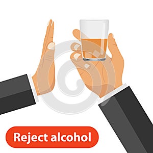 The hand rejects alcohol. One hand holds out a glass with alcohol, the other rejects it. The concept of a sober life. photo