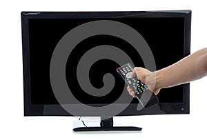 Hand with remote control turning on led tv