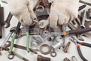 Hand of repairman in gloves with wrench to tighten the nut
