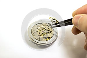 Hand repairs an old mechanical watch