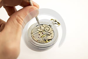 Hand repairs an old watch