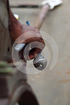 Hand of rickshaw puller with bell