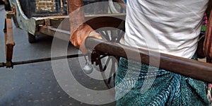 Hand of rickshaw puller with bell