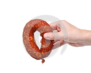 Hand with a ring of tasty smoked sausage on a white background