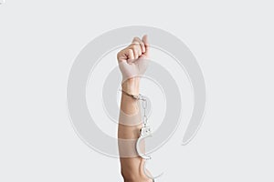 Hand rising up with unchained handcuff,  on white background