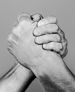 Hand rivalry vs challenge strength comparison. Two men arm wrestling. Arms wrestling. Closep up. Friendly handshake