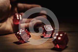 Hand rolling dice. risk, luck and gambling concept