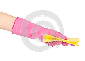 Hand in a rubber glove for cleaning yellow rag for cleaning isolated