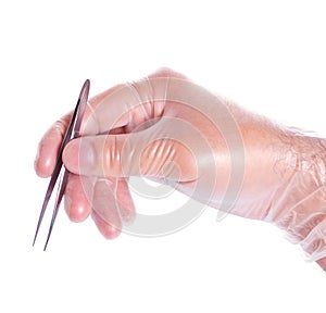 Hand in rubber glove holding tweezers