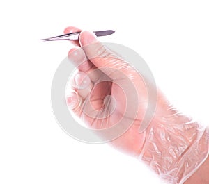 Hand in rubber glove holding tweezers