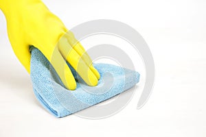 Hand with rubber glove wiping with a cloth