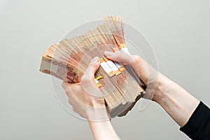 Hand with russian roubles bills on white background