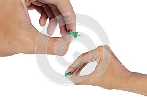 Hand's attaching a green thumbtack