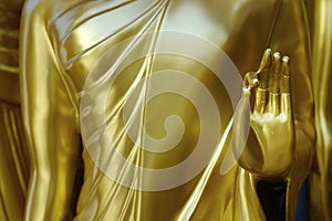 Hand `s detail of statue of buddha, in buddhist temple