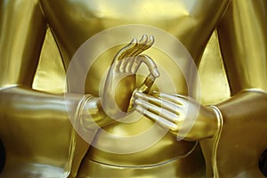 Hand `s detail of statue of buddha, in buddhist temple