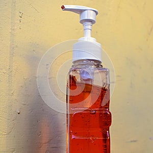 Hand sanitizer alcohol gel rub clean hands hygiene prevention of coronavirus virus outbreak. Man using bottle of sanitizer