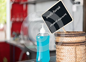 Hand sanitizer and black board  sign for safety and attention in restaurant due to Covid-19