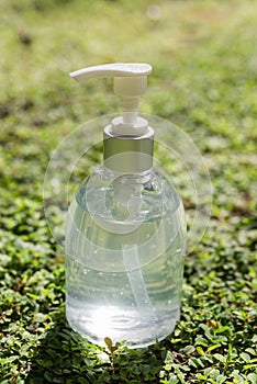 Hand sanitizer bottle,alcohol gel antibacterial protect coronavirus,flu on green grass background