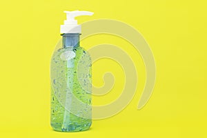 Hand sanitizer bottle or alcohol gel for hand cleasing on yellow backgoumd and copy space