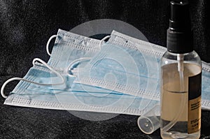 Hand Sanitizer Bottle and Three Medical Masks photo