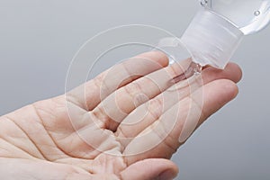 Hand sanitizer bottle using alcohol gel rub for corona virus hands hygiene coronavirus pandemic prevention photo