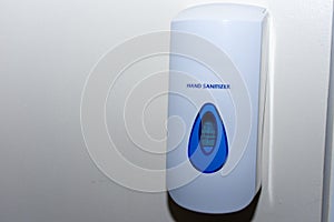 Hand sanitizer dispenser on a wall to protect against illness, bacteria and sickness. Cleanliness and flu concepts