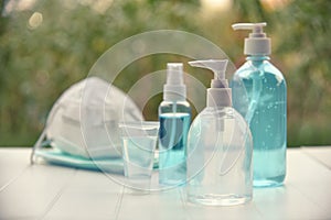 Hand sanitizer gel alcohol and medical masks. photo