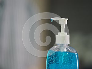 Hand Sanitizer, gel alcoholic mixture with gelatin in clear Plastic bottle with pump pushing wash clean dirty to prevent germs