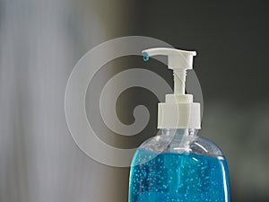 Hand Sanitizer, gel alcoholic mixture with gelatin in clear Plastic bottle with pump pushing wash clean dirty to prevent germs