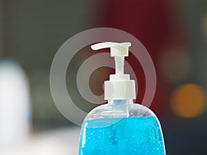 Hand Sanitizer, gel alcoholic mixture with gelatin in clear Plastic bottle with pump pushing wash clean dirty to prevent germs