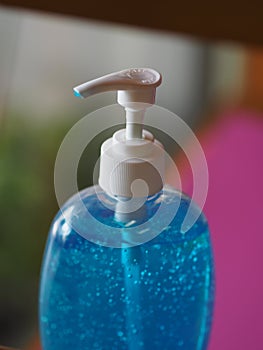 Hand Sanitizer, gel alcoholic mixture with gelatin in clear Plastic bottle with pump pushing, washing clean dirty to prevent germs