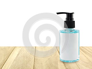 hand sanitizer in transparent bottle with pump lid on desk with copy space