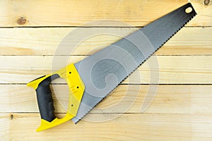 Hand saw on wooden background, carpenter`s tool, woodworking tool