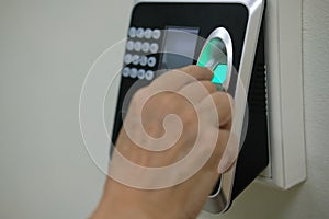 hand scanning finger print on access control machine. hour work