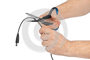 Hand with scissors and computer cable