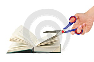 Hand with scissors cutting book