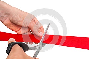 Hand with scissors cutting red ribbon - opening ceremony