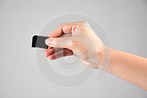 Hand and SD memory card  on white background