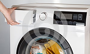 The hand select settings for laundry on modern digital display. Close-up view of automatic washing machine with touch screen on