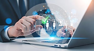Hand selecting a person icon with green checkmark on digital interface technology