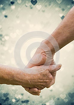 Hand of senior couple holding hands