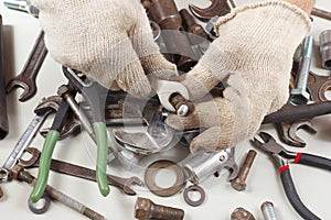 Hand of serviceman in gloves with wrench to tighten the nut