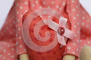 Hand sewing with red fabric and button closeup. Handmade concept