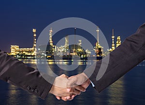 Hand shake between a businessman on Petrochemical factory background