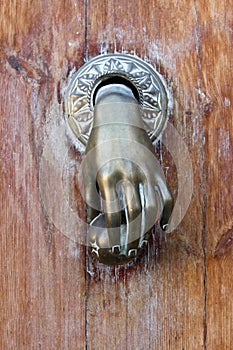 Hand shaped door knocker