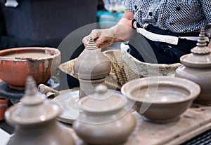 hand shaping traditional clay hollow sculpture tip on pottery wheel