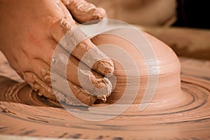 Hand shaping wedge of clay