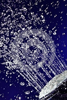 Hand shower douche with stopped motion water drops photo