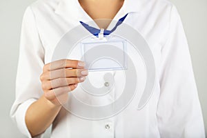 Hand showing blank white bagde photo