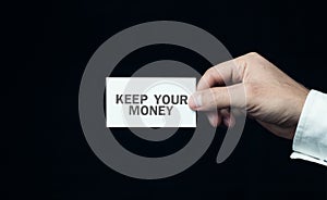 Hand showing business card with a keep your money word.
